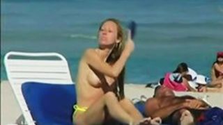 Topless beach voyeur shots of cute girls relaxing themselves