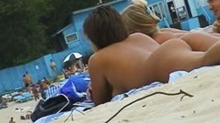 Beach voyeur porn featuring two hot girls and a guy sunbathing naked