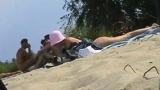 Hot dark haired girl and her friend in this beach spy cam video