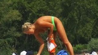 Lusty naked girl caught on cam by a horny beach voyeur.