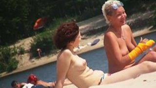 Boobs and asses of mature nudist women shots by beach voyeur