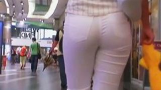 Beauty in tight white pants stars in a candid street video