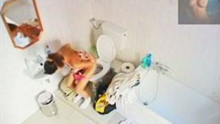A magnificent brunette takes a piss in a bathroom porno video