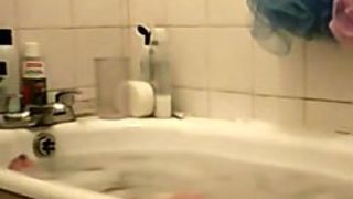 Young bimbo voyeured washing in the soaped bath