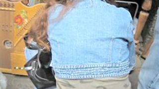 Girl in jeans outfit is on her hunkers showing candid ass