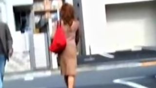 Redhead babe got skirt sharked and her butt peeped a bit