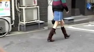 Asian babe confidently walking gets skirt sharked.