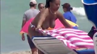 Plump breasted girl caught in a voyeur beach nudism video