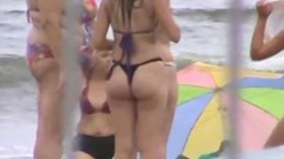 Voyeur video of great big fat tail ends on the beach