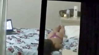 A window peep vid with a gal lying on the bed