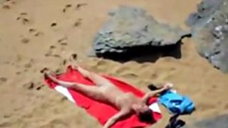 Nude girl on beach sunning.