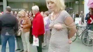 Submissive woman bound and exposed in public