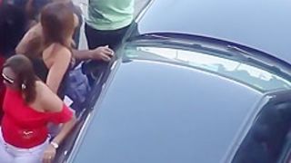 Girls pissing in a parking lot