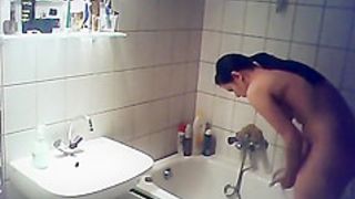 Cute brunette girl spied in bathroom