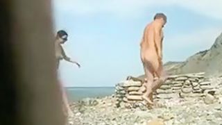 Spy cam clip with an amateur couple making love on a beach
