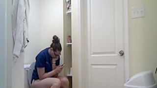 Chubby girl in glasses taking a long pee
