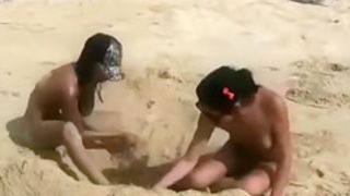 Nude beach foreplay and lesbian licking with brunettes