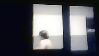 woman spied topless through window