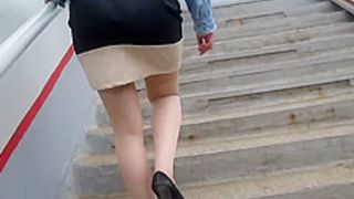 Girl in tan stockings going upstairs