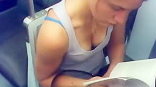 Busty teen girl reading in the train