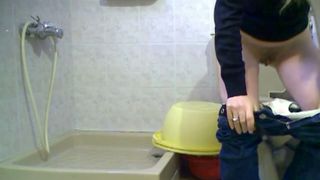 Blonde girl in jeans is peeing on the hidden cam in toilet