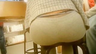 Hot woman sitting on a stool has her huge butt filmed