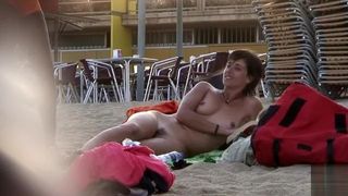 Attractive Italian woman sunbathes completely naked